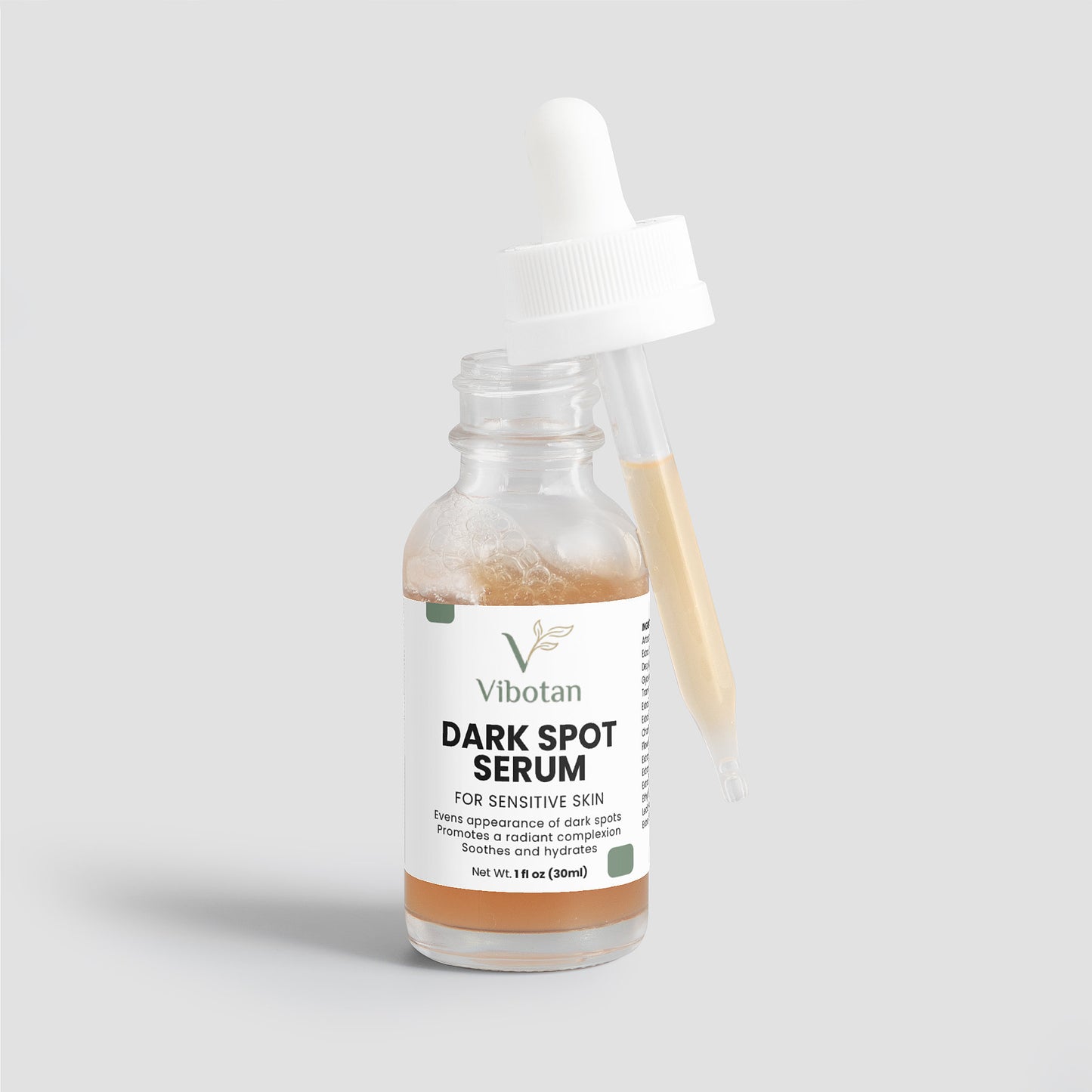 Vibotan dark spot serum bottle with applicator on a light gray background