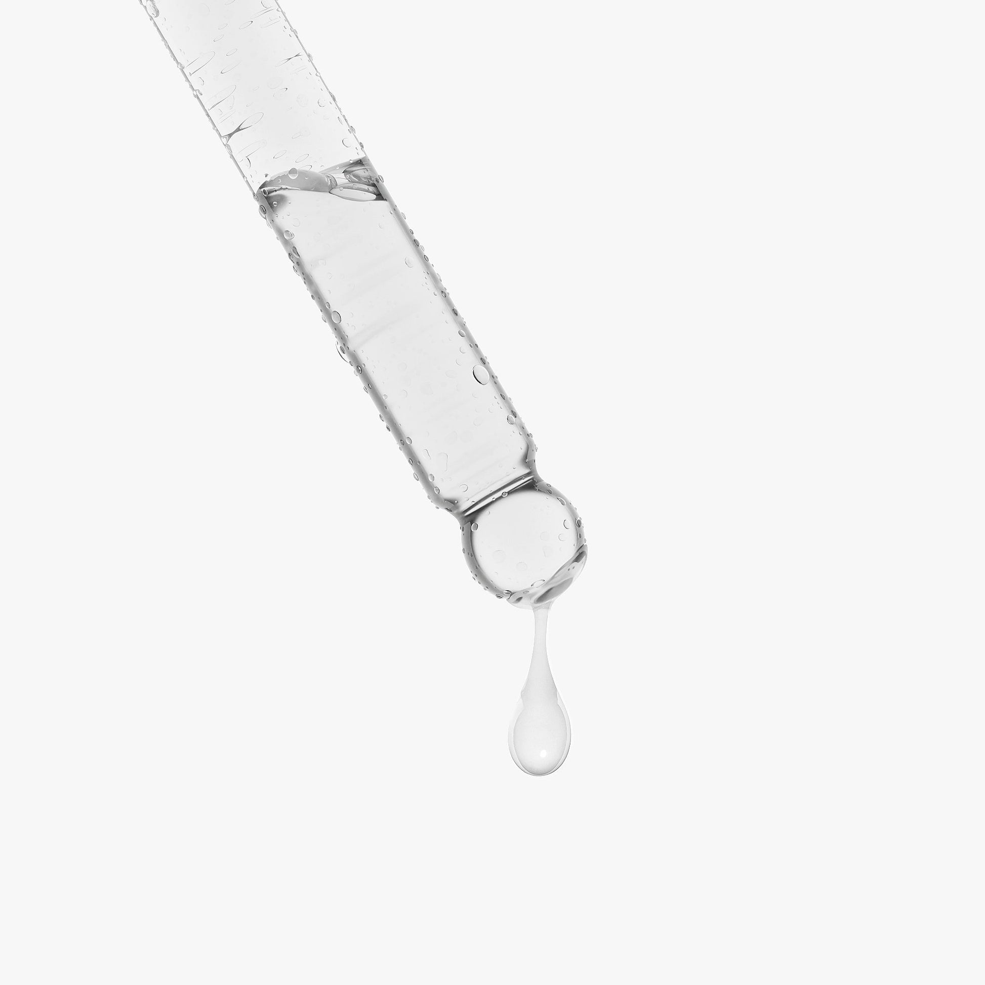 Syringe with clear liquid and a drop falling, on a white background