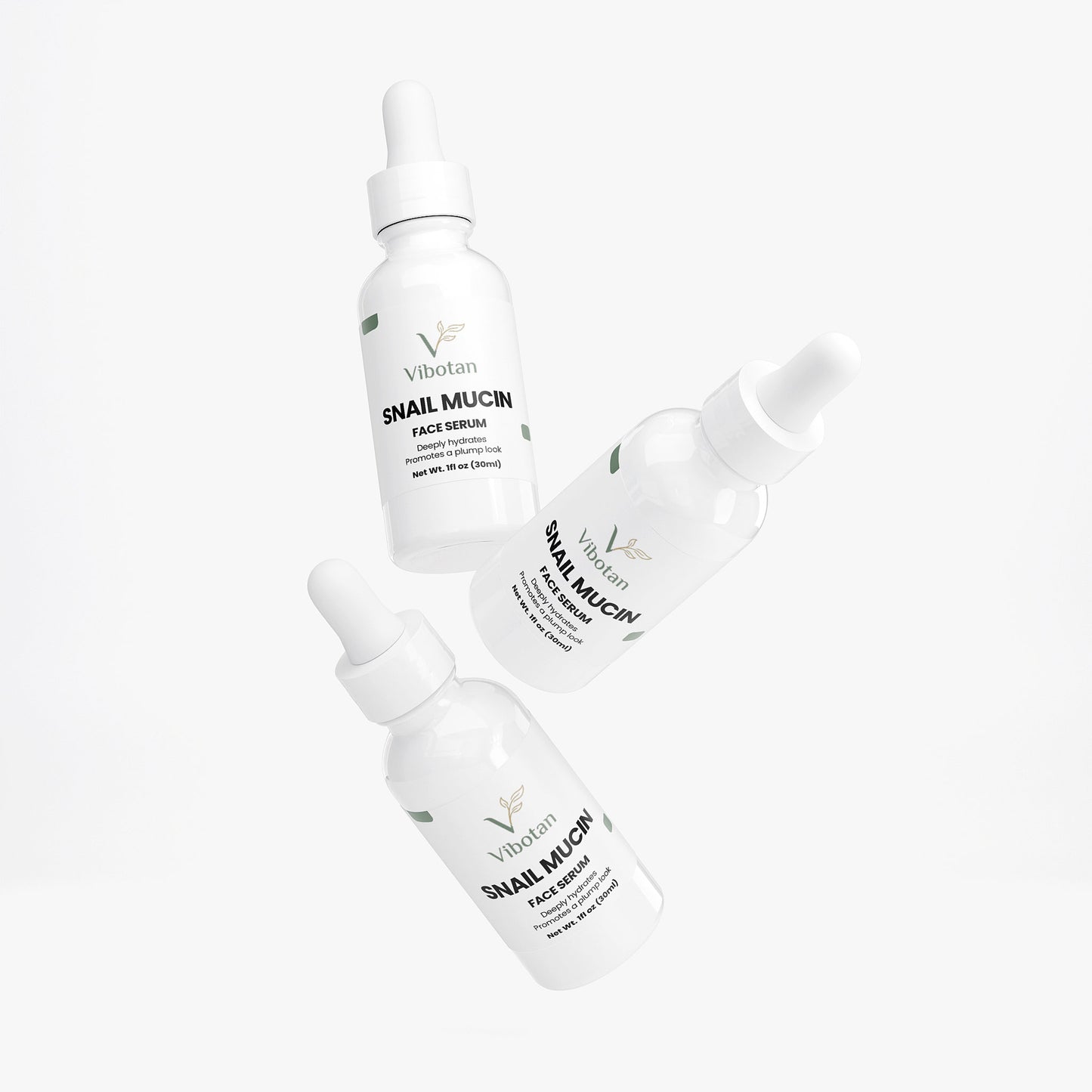 Three bottles of intuia Vitamin Glow serum on a white background