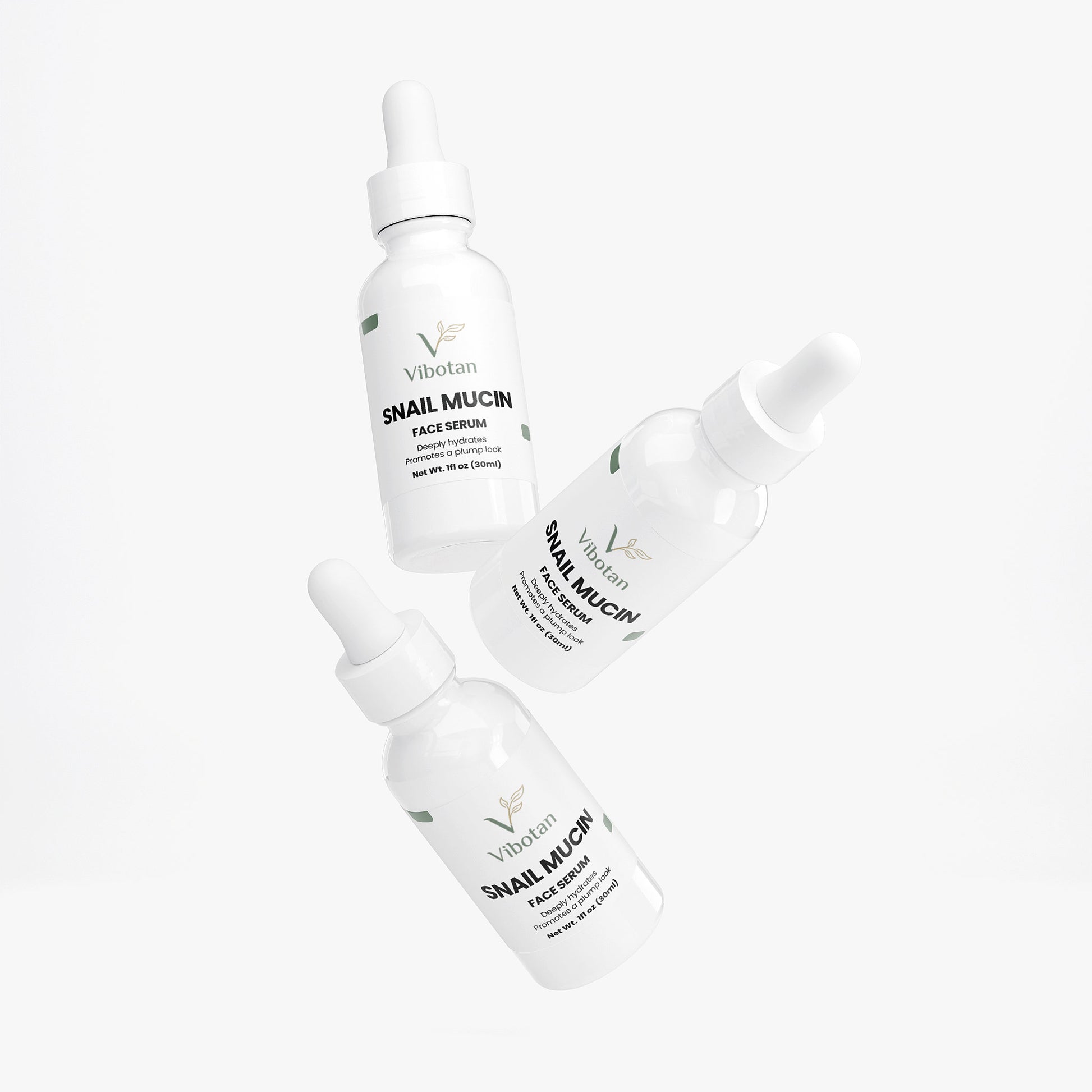 Three bottles of intuia Vitamin Glow serum on a white background